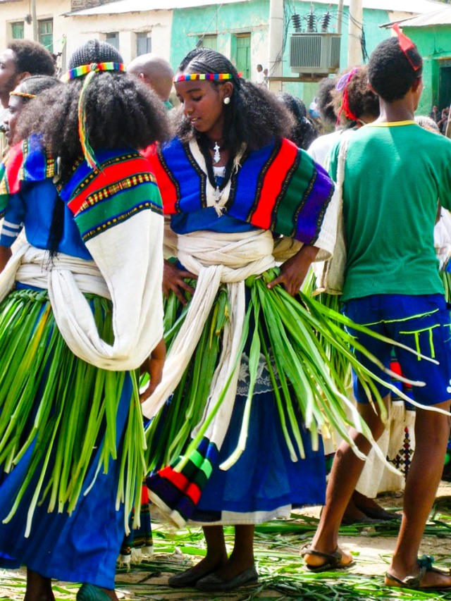This is the traditional Ashenda outfit for women of Abi Adi: braided hair, headband, scarf, jewelry, new dress, and a grass skirt (called the Ashenda).